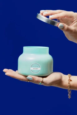 Capri Blue Volcano Candle No. 6 - 19 oz Signature Scent -ROOLEE FASHION SHOP Capri Blue Spring 2021 signature aqua hand lifting lid 2991 cropped high res